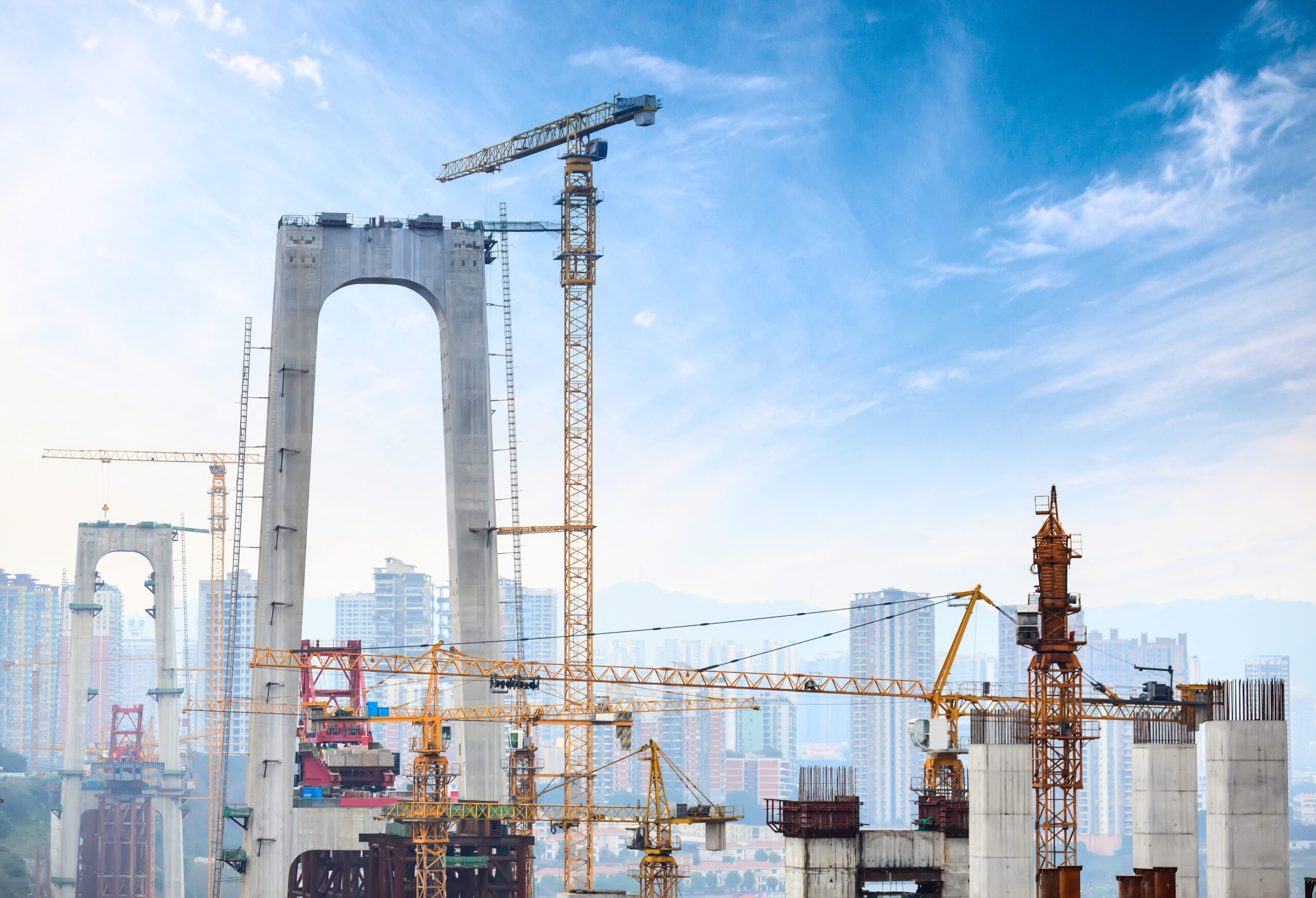 construction of tall concrete pylon of bridge using tower crane
